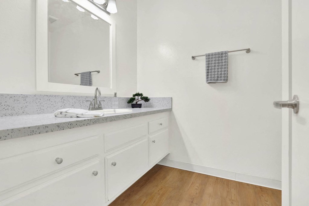 a bathroom with a sink and a mirror at Camino de Oro Apartments, Torrance, CA, 90505