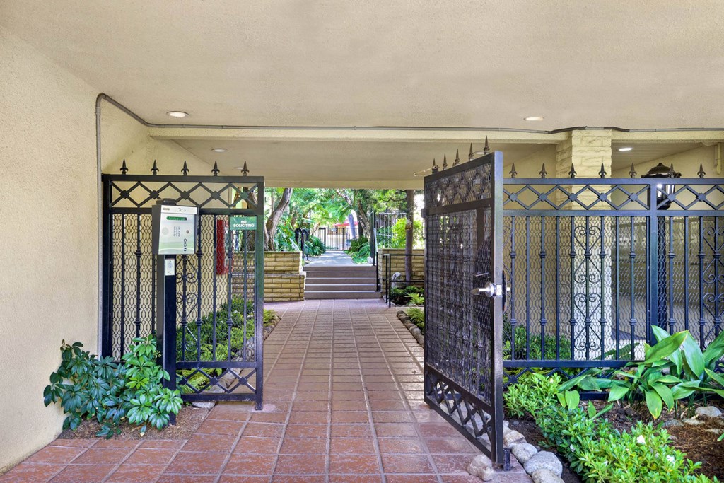 the entrance to a building with a gate and a courtyard at Casa De Oro Apartments, Torrance