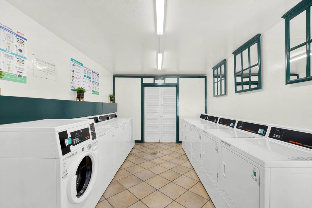 a washer and dryer in a laundry room with washing machines at Casa De Oro Apartments, Torrance, 90505