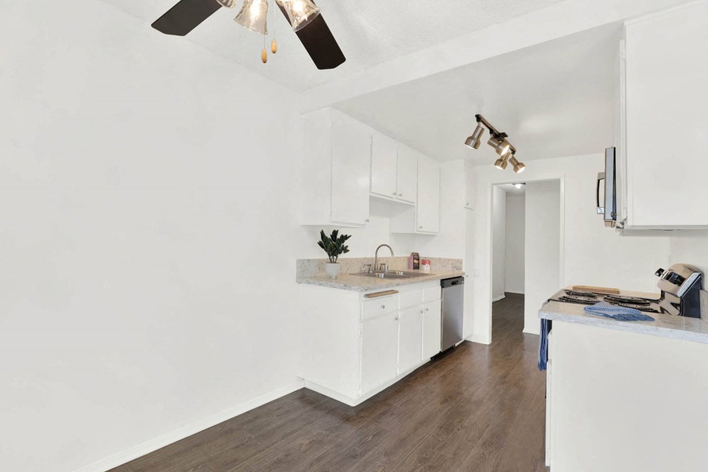 a kitchen with white cabinets and a counter top at Casa De Oro Apartments, Torrance, CA 90505