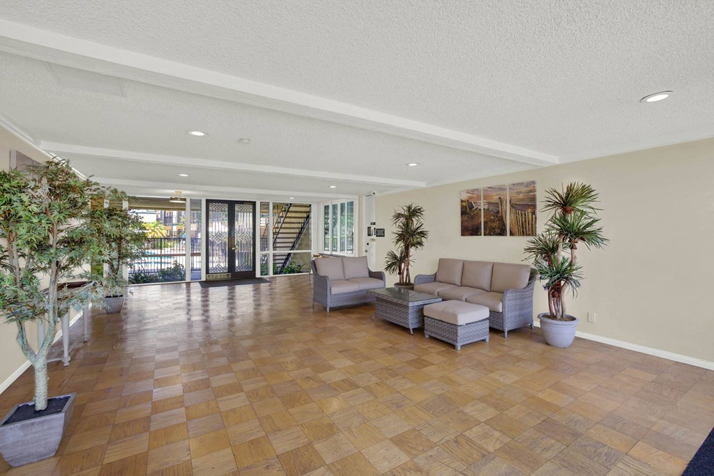 a large living room with a couch and a table at Copa Triana Apartments, Torrance, CA