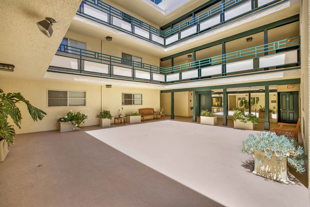 a large room with many windows and plants in it  at Royal Towers Apartments, Redondo Beach, CA, 90277