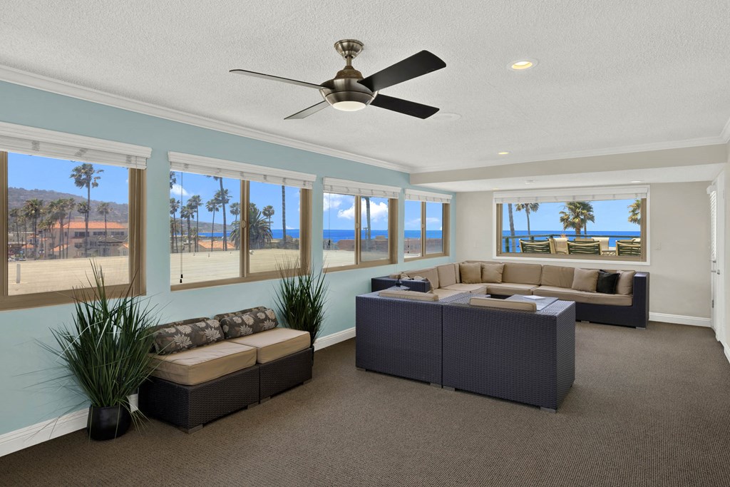 a living room with couches and a table and a ceiling fan  at Royal Towers Apartments, Redondo Beach, CA, 90277