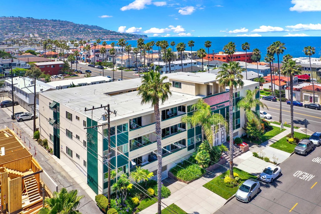 an aerial view of a building with palm trees and the ocean in the background  at Royal Towers Apartments, Redondo Beach, 90277