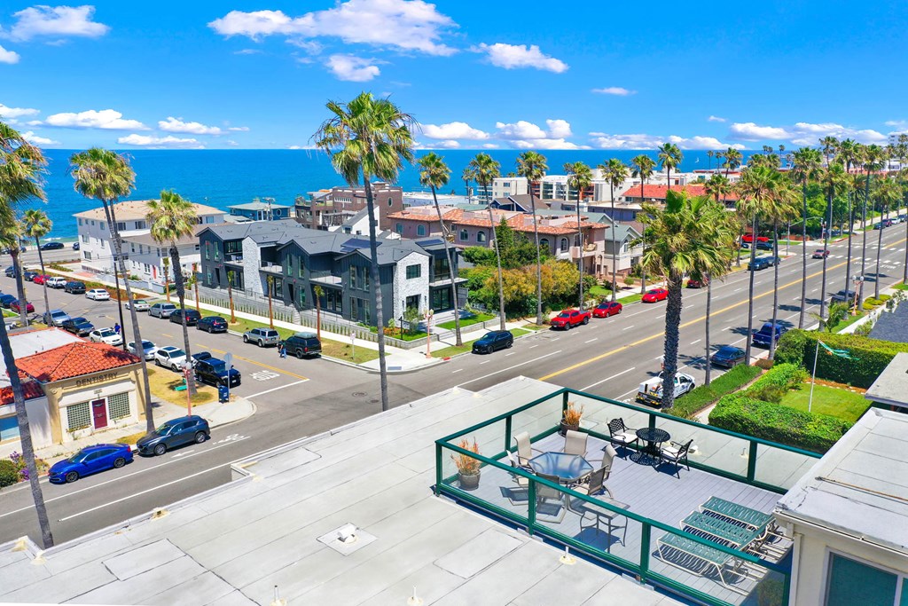 a balcony with a view of the ocean and palm trees at Royal Towers Apartments, Redondo Beach, CA