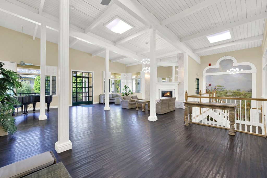 a large living room with a fireplace and a staircase at Willow Tree Apartments, Torrance, CA