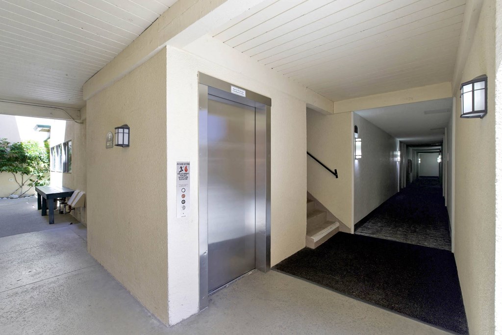 a metal elevator in a hallway of a building  at Willow Tree Apartments, Torrance, CA, 90505