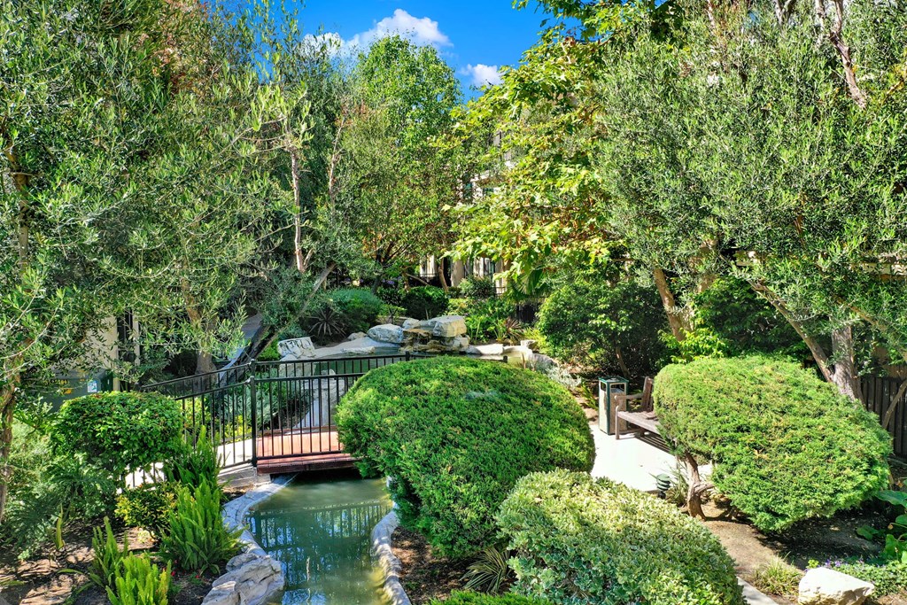 a bridge over a pond in a garden at Willow Tree Apartments, Torrance, CA, 90505