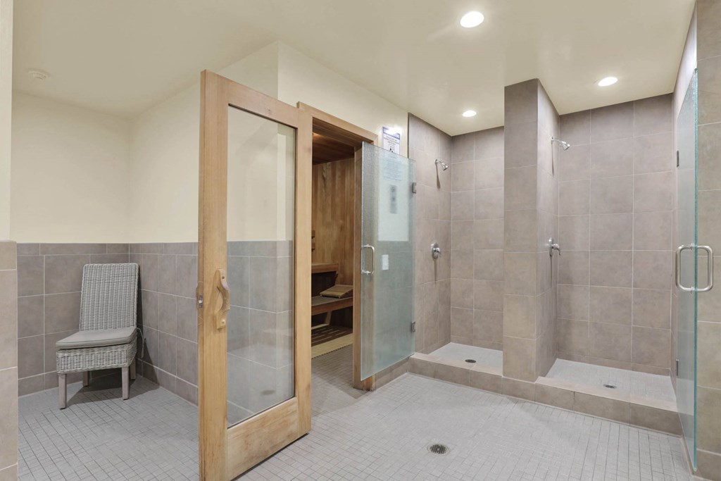 a large bathroom with a shower and a chair at Willow Tree Apartments, Torrance