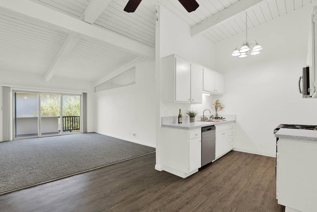 an open kitchen and living room with white walls and wood floors  at Willow Tree Apartments, Torrance, CA, 90505