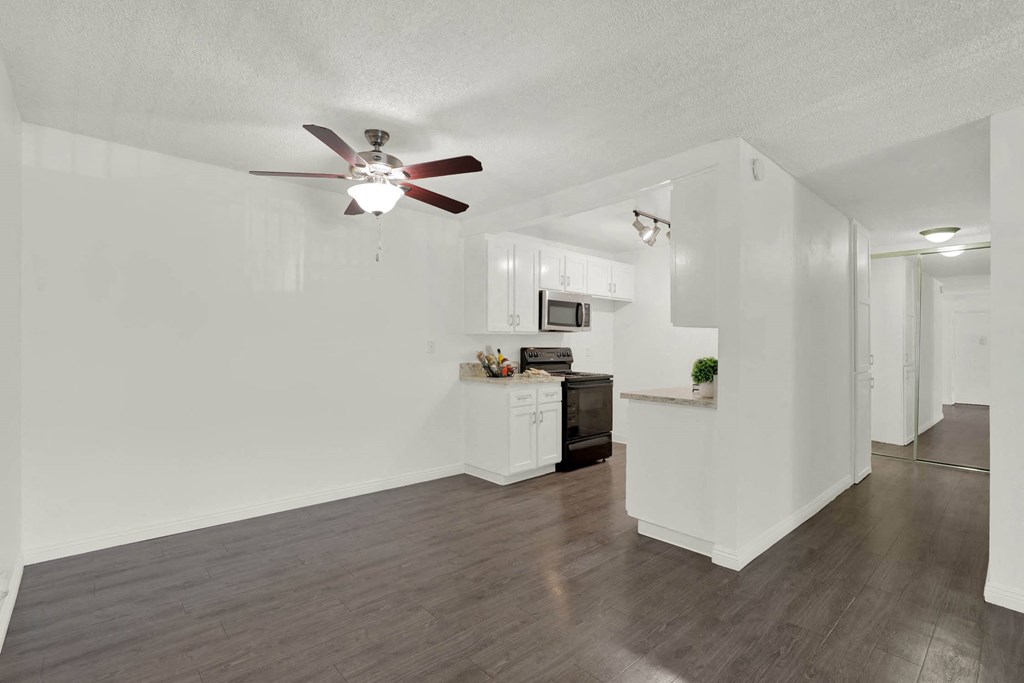 a living room and kitchen with a ceiling fan at Willow Tree Apartments, Torrance, CA, 90505