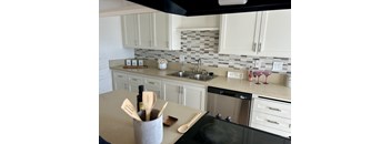 A kitchen with a black stove top oven and a white counter top at Royal Towers Apartments, Redondo Beach, CA, 90277
