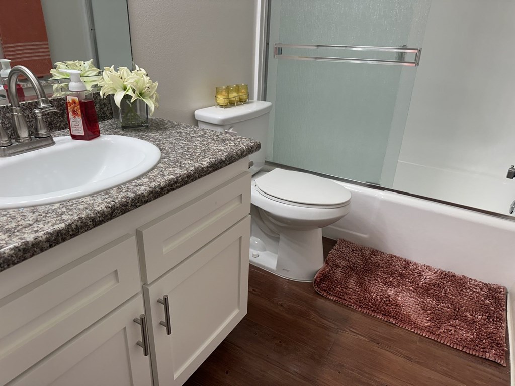 A bathroom with a sink, toilet, and shower.  at Casa De Oro Apartments, Torrance, 90505