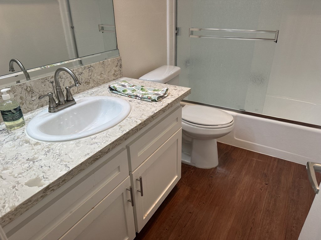 A bathroom with a sink, toilet, and shower.  at Casa De Oro Apartments, Torrance, 90505