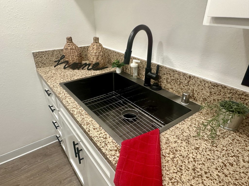 A kitchen counter with a sink and a red towel at Willow Tree Apartments, California, 90505