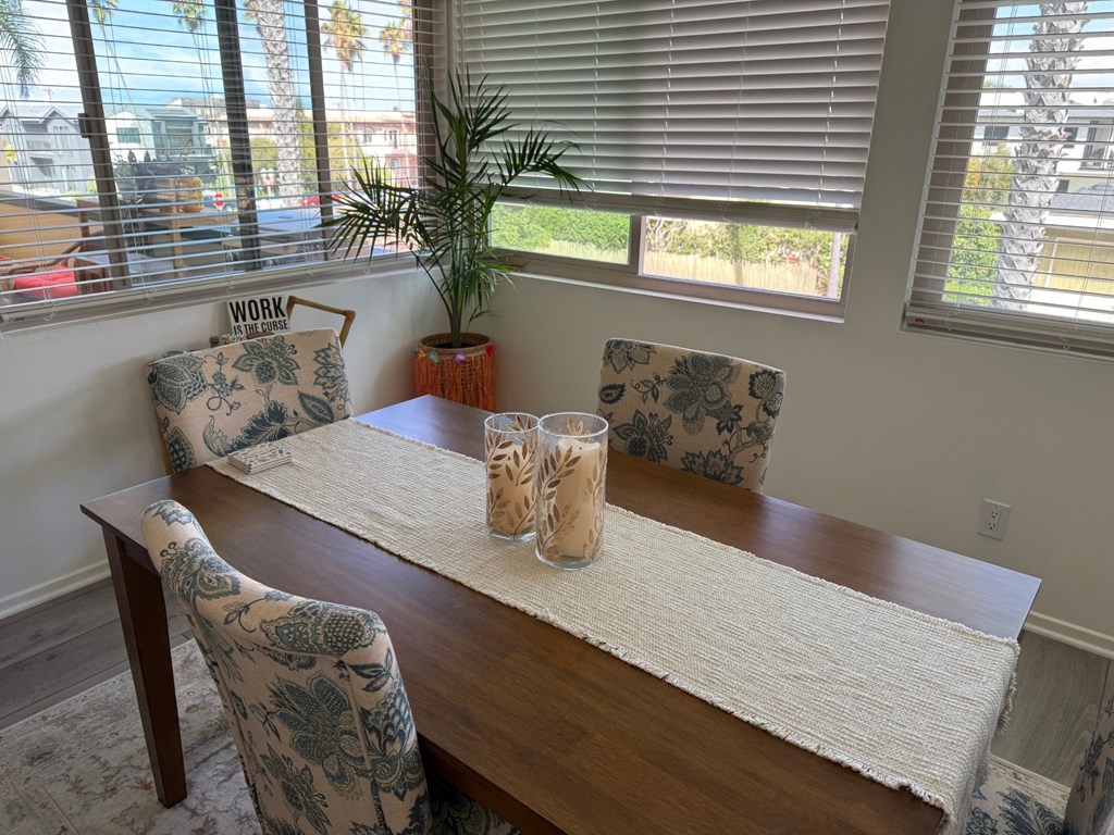 A dining room with a wooden table and chairs.