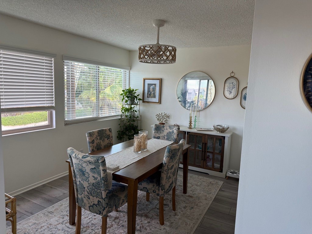 A dining room with a table and chairs.