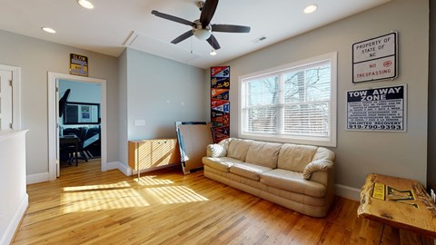 A living room with a tan couch and a wooden coffee table.