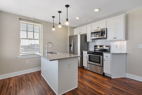 A kitchen with a stove top oven and a microwave above it.