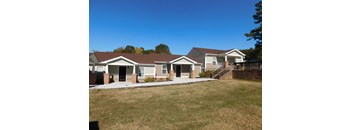 A row of houses with a clear blue sky above them.