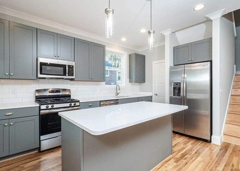 A modern kitchen with a large island in the center.