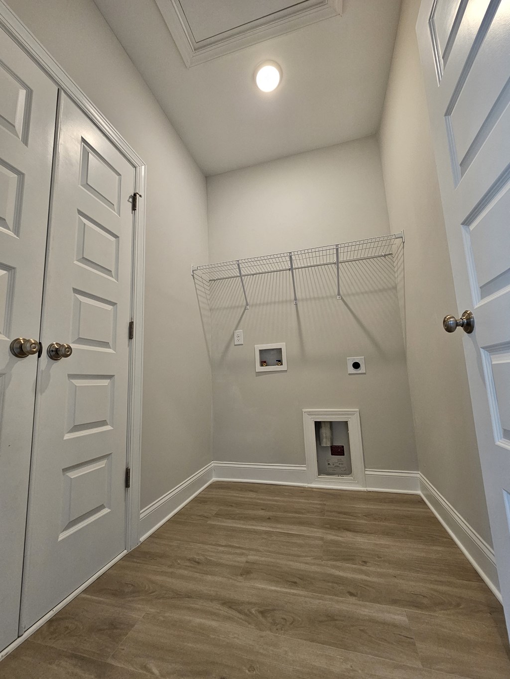 a room with a hallway with a closet and a door