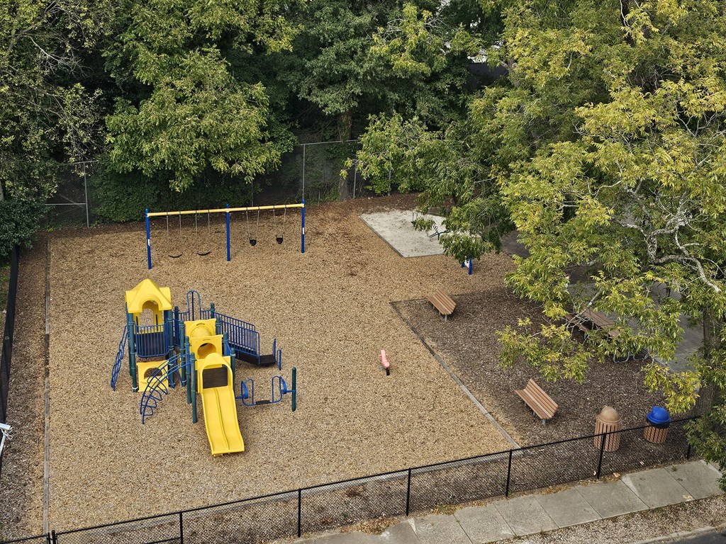 a playground is shown in a backyard with trees