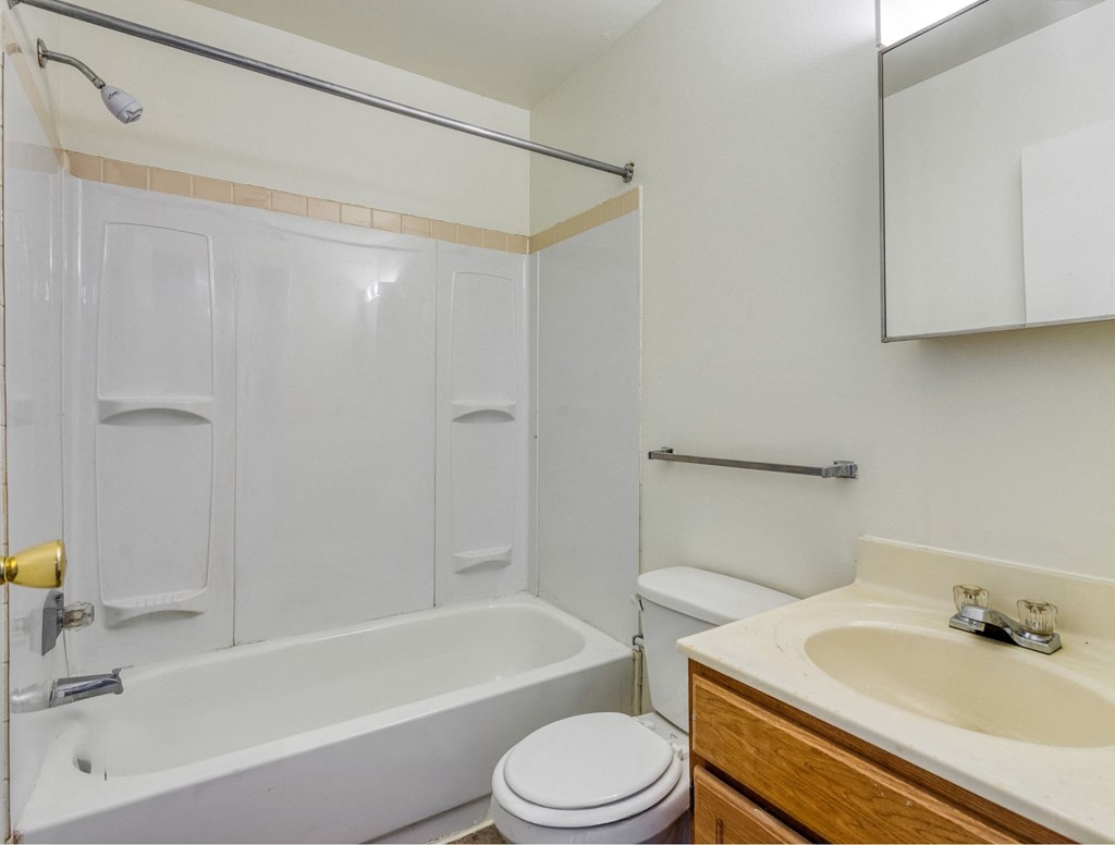a bathroom with a sink toilet and a tub