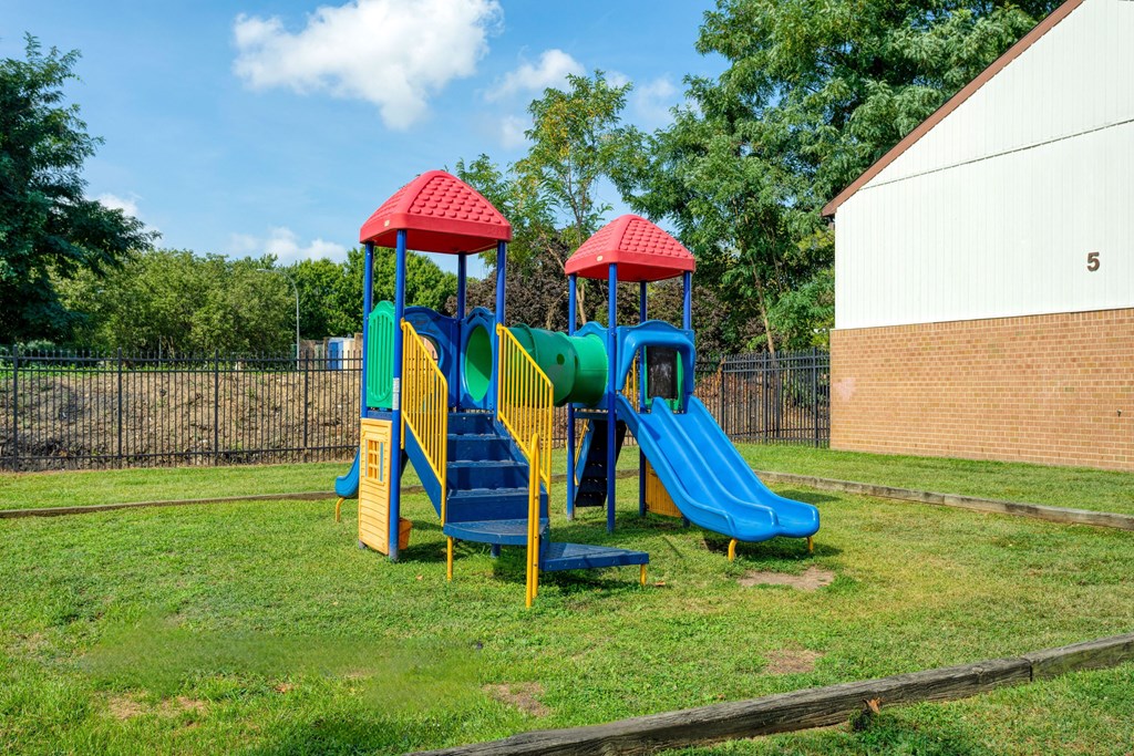 a playground with two slides in a yard