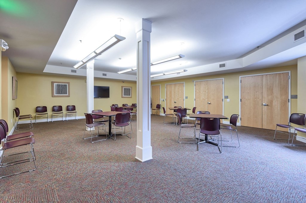 a large room with tables and chairs in it