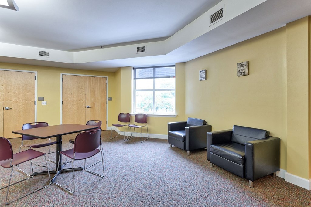 a waiting room with chairs and a table