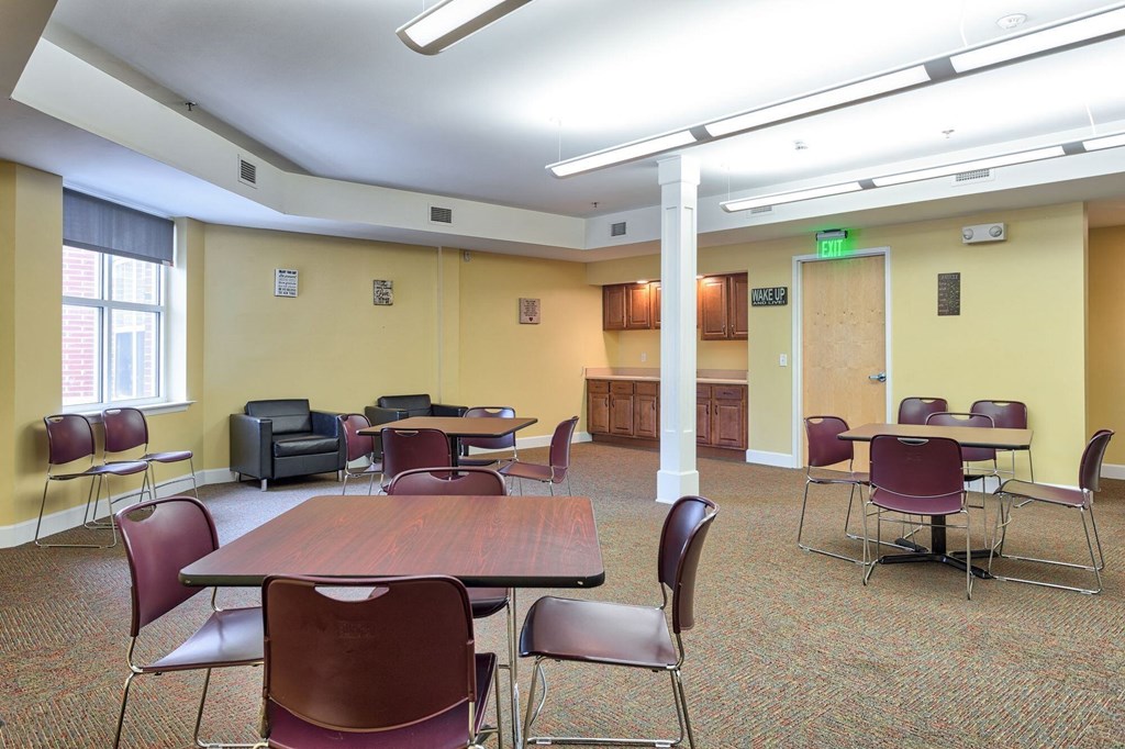 a large room with tables and chairs and a counter