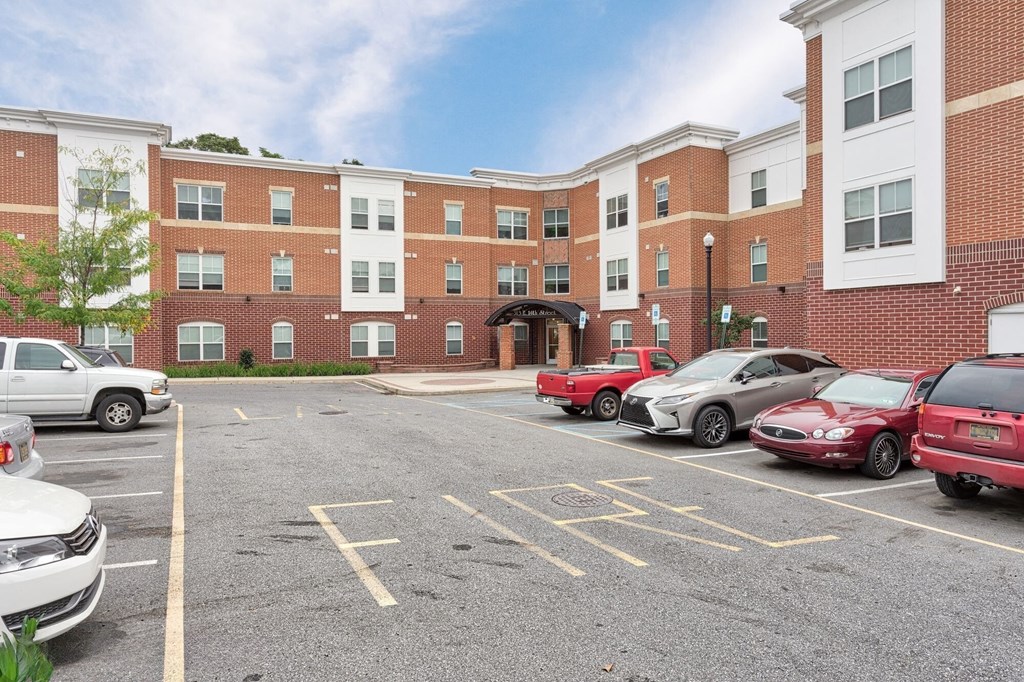a parking lot with cars in front of a brick building