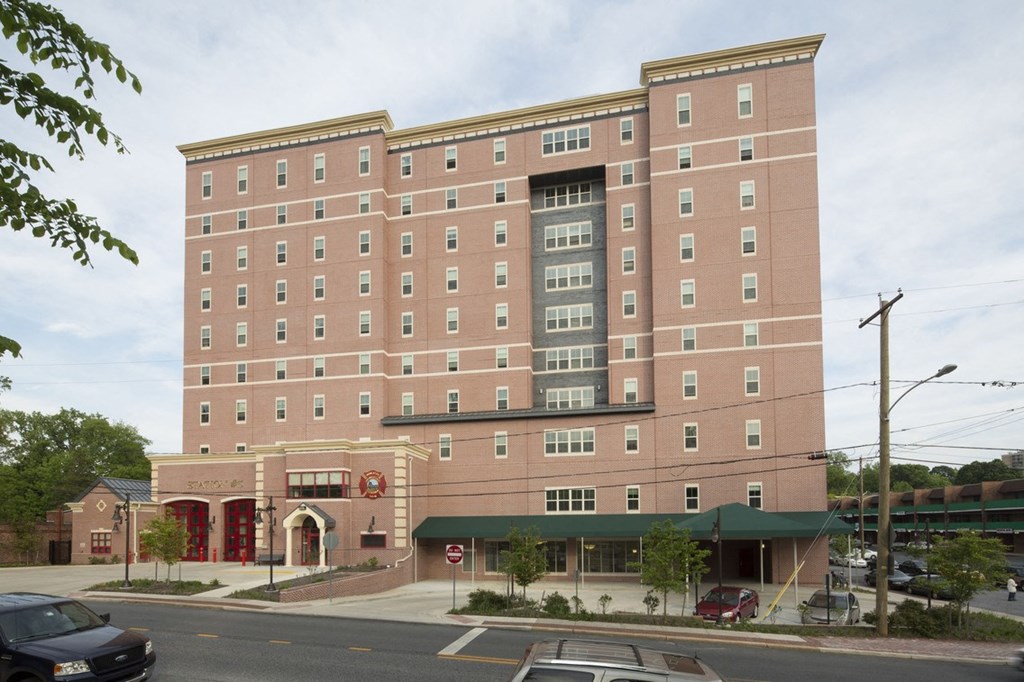 a tall brick building with a street in front of it