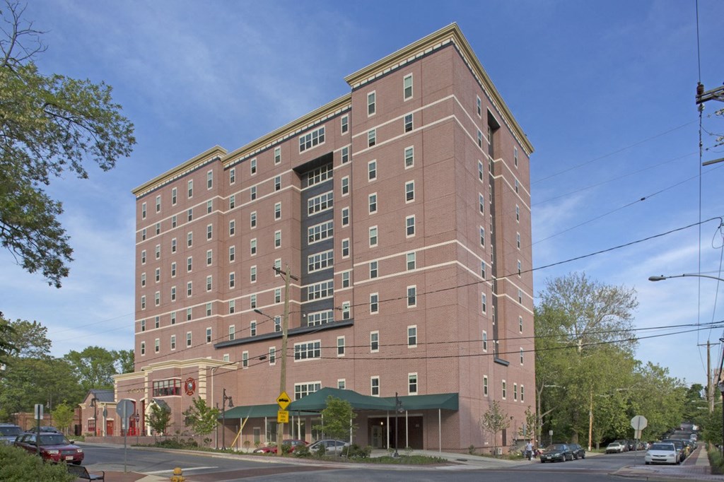 a brick building on a city street with a blue sky