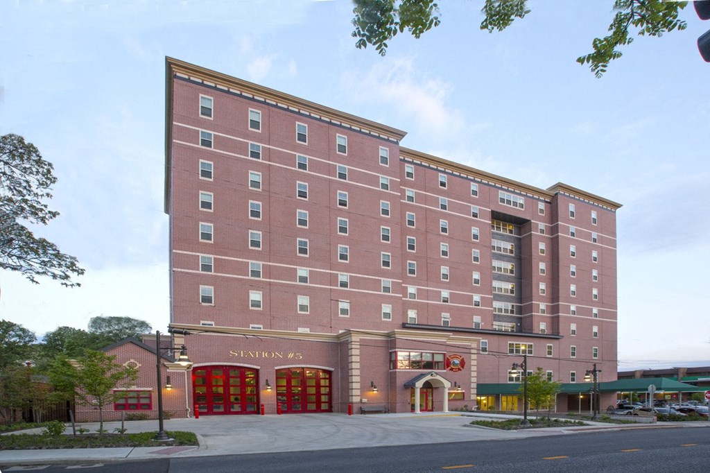 a large brick building with a street in front of it