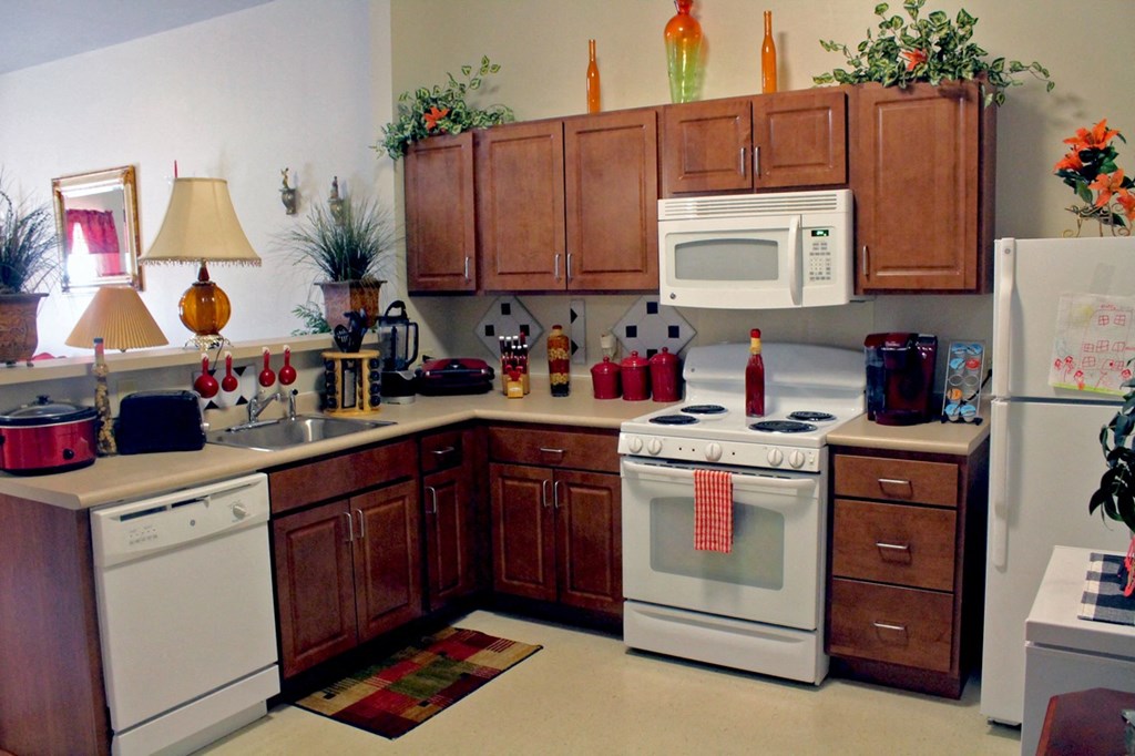 a kitchen with white appliances and wooden cabinets