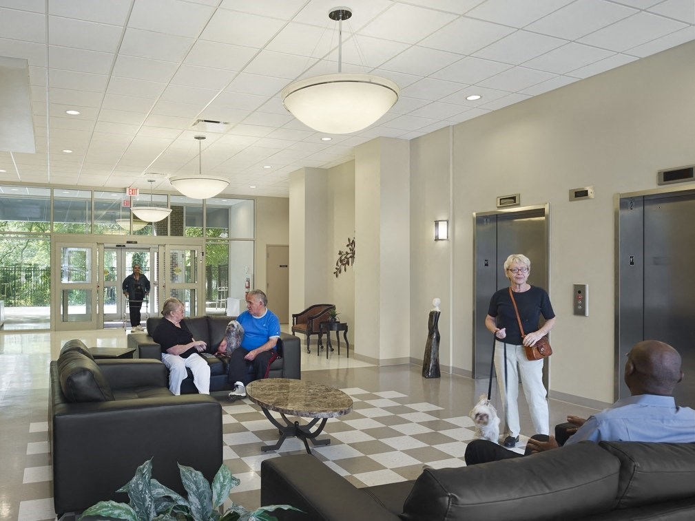 a group of people in a lobby of a building