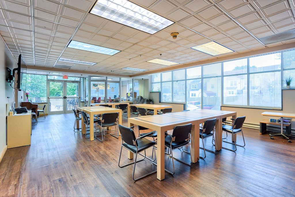 a large room with tables and chairs in a classroom