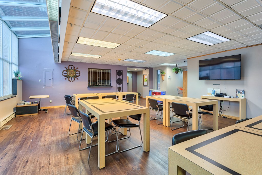 a dining room with tables and chairs and a tv