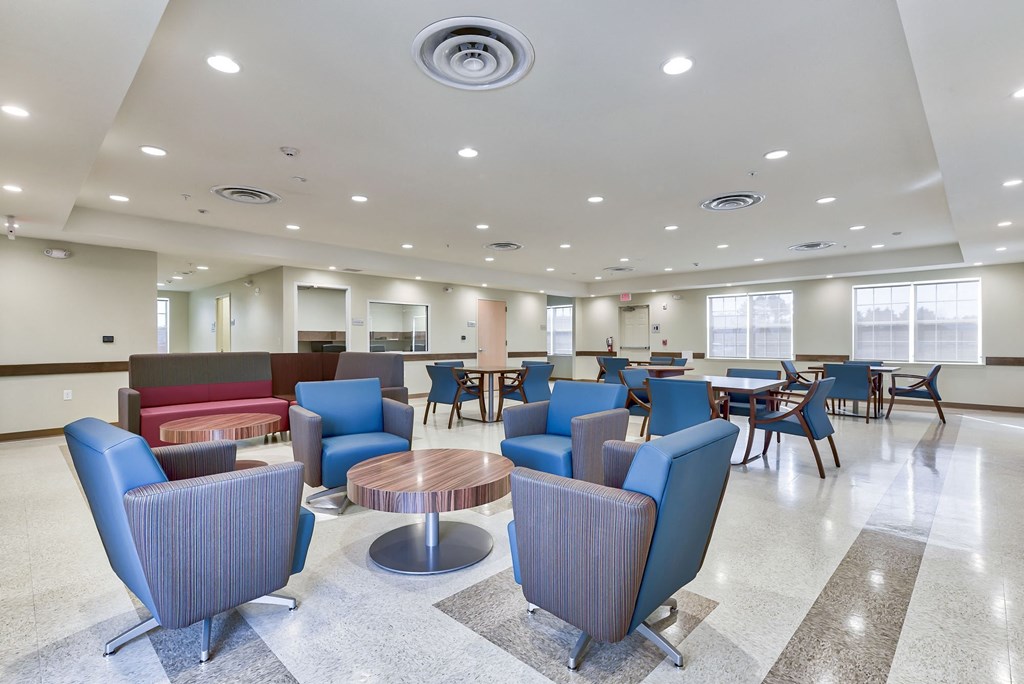 a common area with chairs and tables in a large room