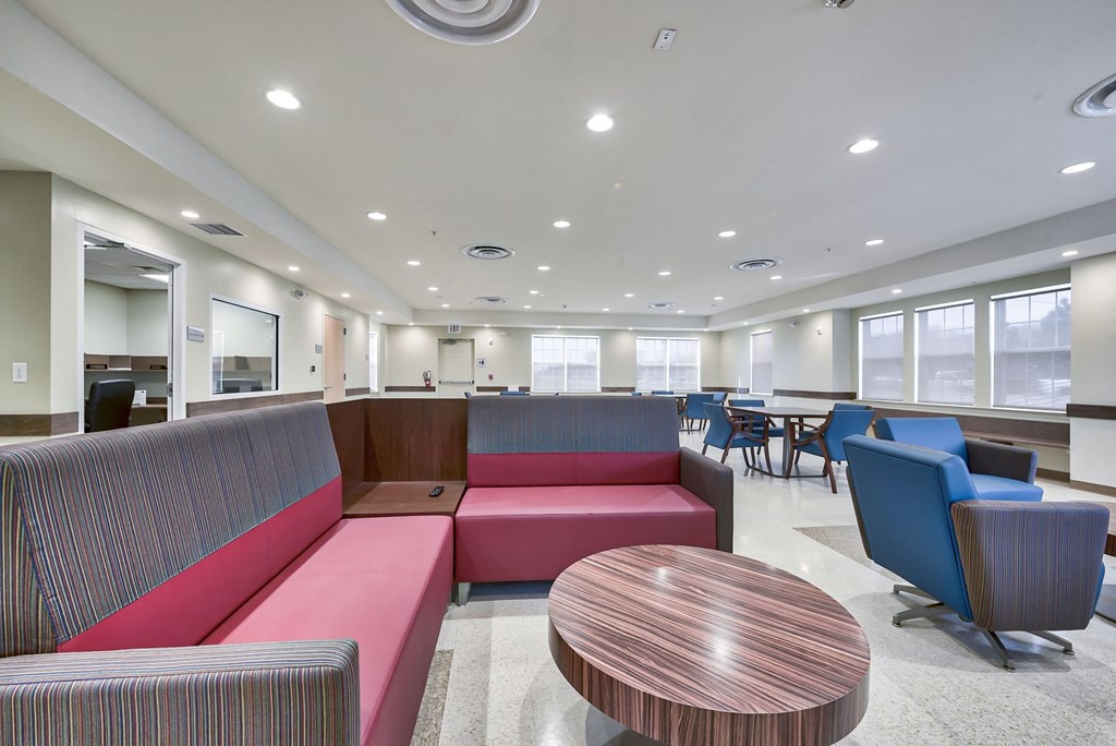 a lounge area with couches and chairs and tables