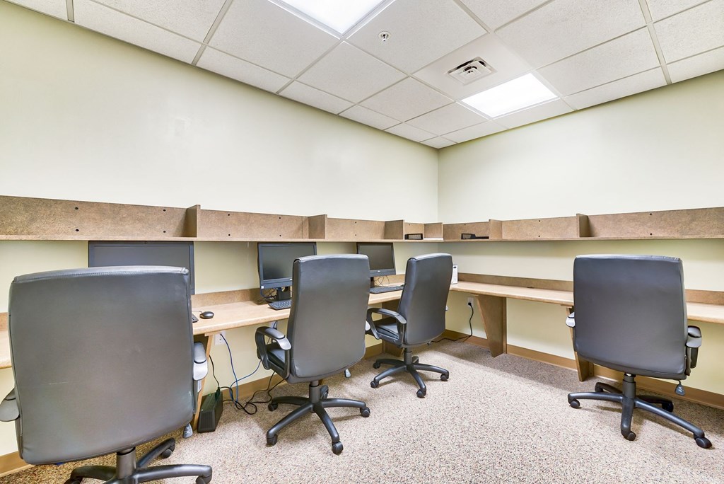 a large room with desks and chairs in it