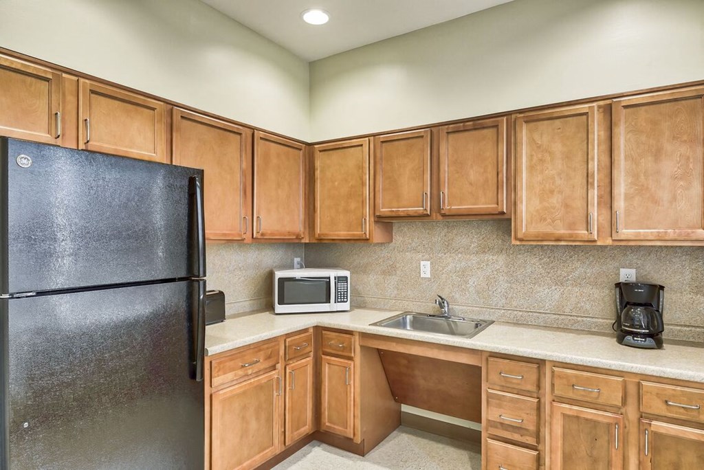 a kitchen with a refrigerator microwave and sink