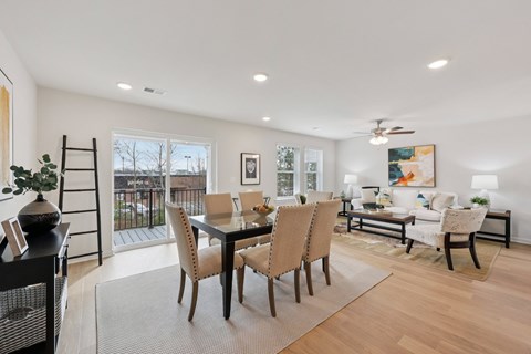A dining room with a table set for six.