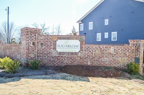 Sugarloaf Landing is a brick building with a sign in front.
