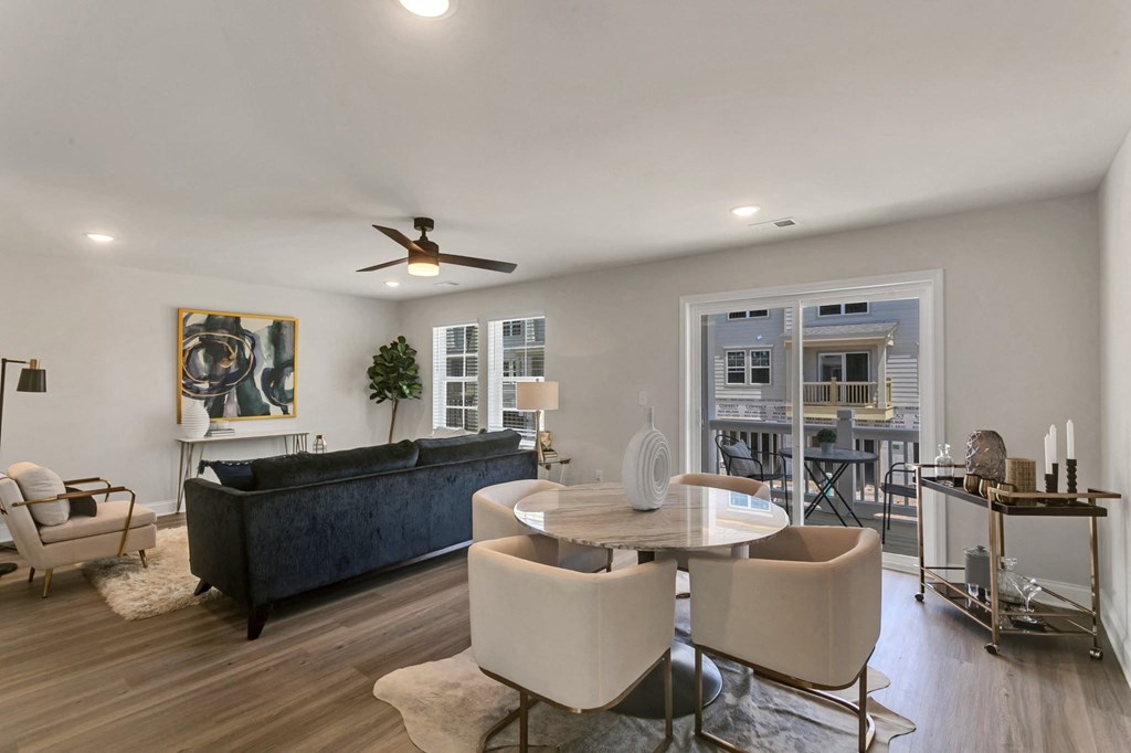 a living room with a couch and a table with chairs