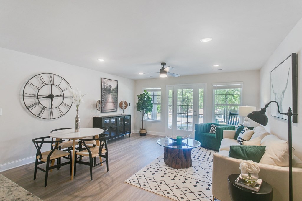 a living room with a large clock on the wall and a couch and a table