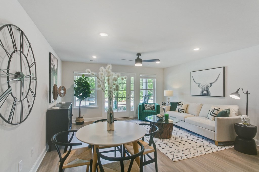 a living room with a large clock on the wall and a couch