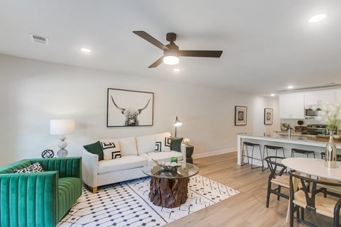 A living room with a green couch and a coffee table.